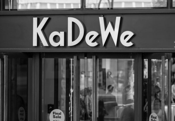 Kadewe department store entrance in black and white.